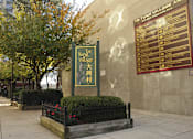 Thumbnail 8 of 8 - a sign for the times village on the side of a building