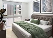 Thumbnail 28 of 36 - Bedroom with a bed and a large window  at Douglas Enclave located in Miami, FL.