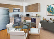 Thumbnail 29 of 36 - Open kitchen and dining room at Douglas Enclave located in Miami, FL.