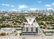 Thumbnail 10 of 15 - A large building with a sign that says "Havana" is in the foreground of a cityscape.