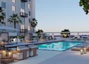 Thumbnail 6 of 15 - A modern poolside lounge area with a view of the city.