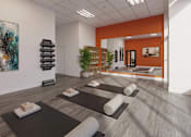 Thumbnail 14 of 17 - A yoga studio with a mirror, a potted plant, and two paintings on the wall.