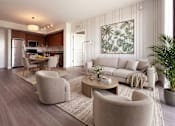 Thumbnail 3 of 15 - A modern living room with a large painting on the wall.