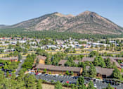 Thumbnail 41 of 42 - A mountain is in the background of a town.