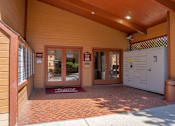 Thumbnail 31 of 42 - The image shows a building entrance with a red mat on the ground and a white cabinet to the right.