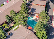 Thumbnail 30 of 42 - A bird's eye view of a neighborhood with houses and a pool.