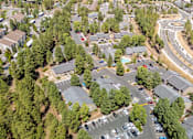 Thumbnail 4 of 18 - A bird's eye view of a residential area with houses and a road.