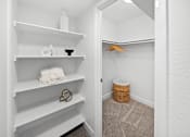Thumbnail 17 of 18 - A white closet with a basket and a hanger.