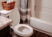 Thumbnail 26 of 26 - a white toilet sitting next to a bath tub