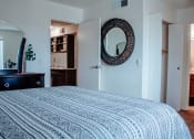 Thumbnail 23 of 26 - a bedroom with a large bed and a mirror