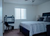 Thumbnail 22 of 26 - a bedroom with a bed and a desk