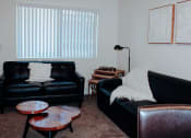 Thumbnail 18 of 26 - a living room with two leather couches and two coffee tables