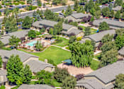 Thumbnail 22 of 34 - A bird's eye view of a residential neighborhood with houses and a swimming pool.