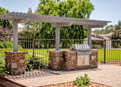 Thumbnail 12 of 34 - A white pergola is supported by two stone pillars.