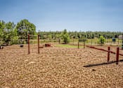 Thumbnail 9 of 34 - A field with red posts and a fence.