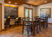 Thumbnail 26 of 34 - A dining room with a wooden table and chairs.