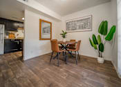 Thumbnail 3 of 34 - A dining room with a wooden table and chairs.