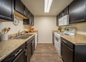 Thumbnail 1 of 34 - A kitchen with black cabinets and a white microwave.