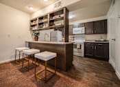 Thumbnail 8 of 21 - A kitchen with a bar stool and a counter.