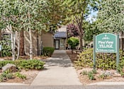 Thumbnail 20 of 20 - A sign that says Pine View Village Welcome Center stands in front of a building.