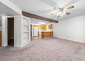 Thumbnail 9 of 16 - A room with a ceiling fan and a carpeted floor.