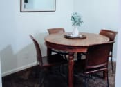 Thumbnail 12 of 26 - a dining room with a table and chairs
