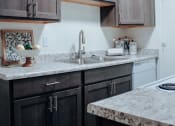 Thumbnail 14 of 26 - a kitchen with a sink and a stove