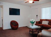 Thumbnail 5 of 26 - a living room with white walls and a brown carpet