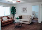 Thumbnail 7 of 26 - a living room with couches and a coffee table