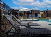 Thumbnail 18 of 21 - our apartments have a large pool with lounge chairs and an umbrella