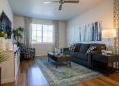 Thumbnail 29 of 32 - a living room with hardwood flooring and a ceiling fan