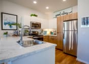 Thumbnail 27 of 32 - a kitchen with stainless steel appliances and a marble counter top