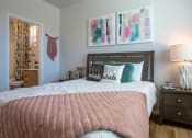 Thumbnail 16 of 21 - a bedroom with a bed and pictures on the wall