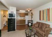 Thumbnail 14 of 31 - Living Room With Kitchen View at Pine View Village Apartments, Flagstaff, 86001