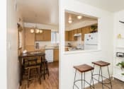 Thumbnail 6 of 36 - Fitted Kitchen With Island Dining at University Square Apartments, Flagstaff, AZ, 86001