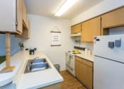 Thumbnail 17 of 56 - Chef-Inspired Kitchens Feature Stainless Steel Appliances at Woodlands Village Apartments, Flagstaff, AZ