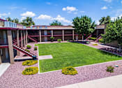 Thumbnail 4 of 22 - view of a courtyard between apartment homes with landscaping