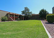 Thumbnail 7 of 22 - a view of the outside of a building with a lawn and a grassy yard