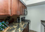 Thumbnail 11 of 29 - Granite Counter Tops In Kitchen at Butterfield Apartments, Flagstaff AZ, 86004
