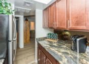 Thumbnail 15 of 29 - Modern Kitchen With Custom Cabinet at Butterfield Apartments, Flagstaff, Arizona