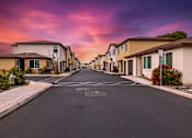 Thumbnail 4 of 32 - A street in a residential area with houses on both sides.