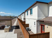 Thumbnail 10 of 32 - a row of houses with balconies and a sidewalk