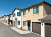 Thumbnail 6 of 32 - a row of townhomes with cars parked in front of them