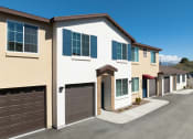 Thumbnail 5 of 32 - a house with two garage doors and a street in front of it