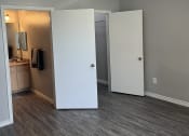 Thumbnail 8 of 17 - an empty living room with a ceiling fan and a closet