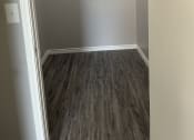 Thumbnail 9 of 17 - an empty room with wood flooring and a white closet