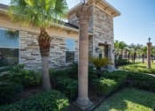 Thumbnail 1 of 9 - a house with two columns and palm trees in front of it