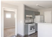 Thumbnail 7 of 10 - an empty kitchen with white appliances and a white counter top