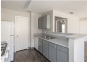 Thumbnail 8 of 10 - an empty kitchen with a sink and a white refrigerator