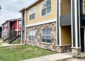Thumbnail 4 of 10 - a row of houses with a sidewalk and grass